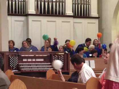 The Choir enthusiastically participating in the task of handing out %22Holy Spirit Balloons%22 following the Children's message, 5-19-2013